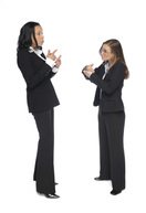 2 women communicating using sign language.